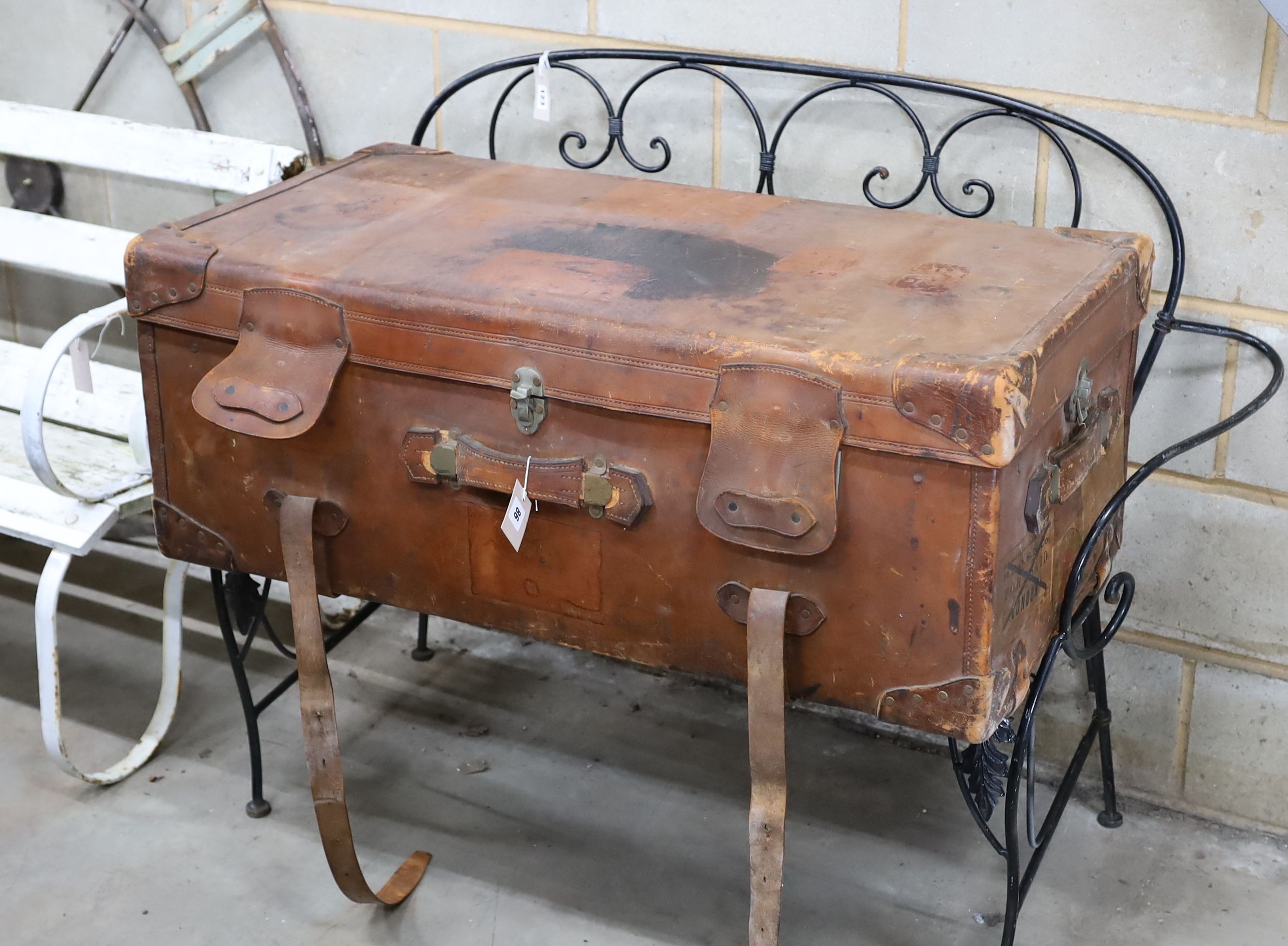 An early 20th century large tan leather trunk with labels, length 100cm, depth 53cm, height 39cm